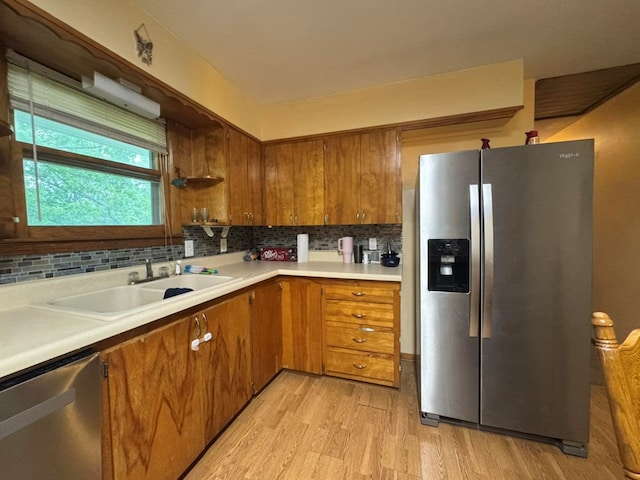 236 N Maple St, Milan, MO 63556 - kitchen with appliances with stainless steel finishes, a sink, light wood-type flooring, and brown cabinets