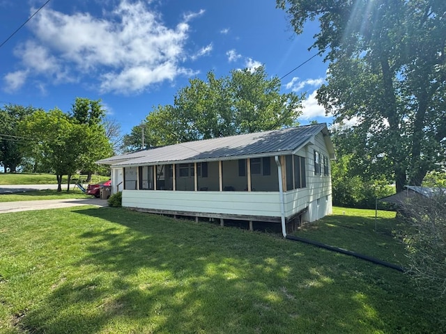 236 N Maple St, Milan, MO 63556 - view of front of house with a sunroom, a front yard, and metal roof