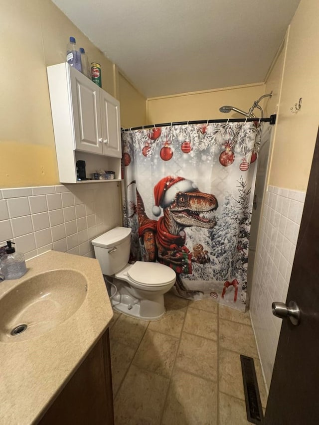 236 N Maple St, Milan, MO 63556 - bathroom featuring tile walls, vanity, a shower with shower curtain, toilet, and wainscoting