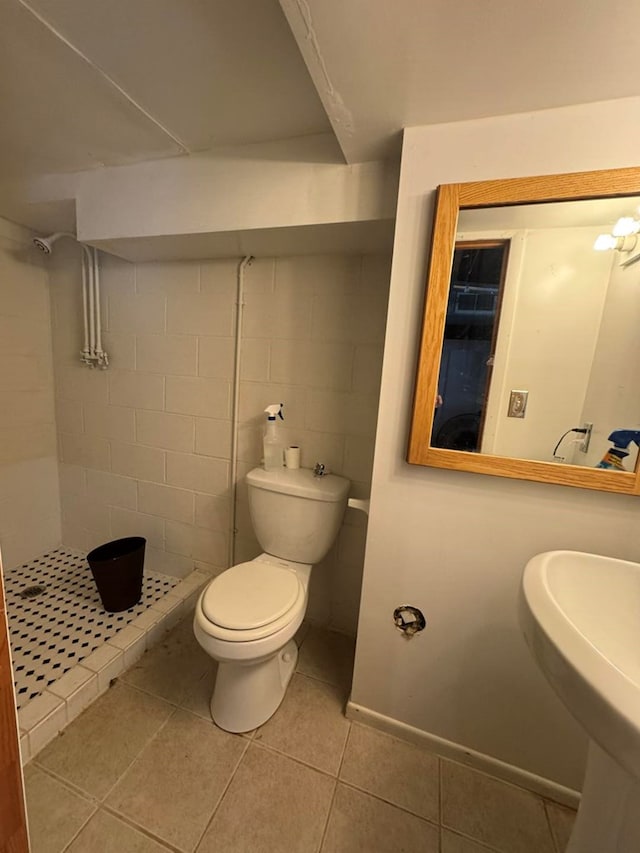 236 N Maple St, Milan, MO 63556 - bathroom featuring a stall shower, toilet, tile patterned flooring, and a sink