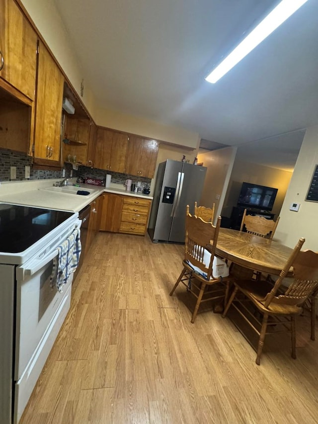 236 N Maple St, Milan, MO 63556 - kitchen featuring stainless steel fridge with ice dispenser, white range with electric cooktop, light wood finished floors, open shelves, and light countertops