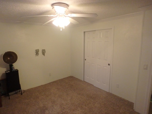 unfurnished bedroom featuring carpet, a closet, crown molding, and a textured ceiling