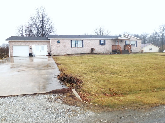 ranch-style house featuring a front lawn, driveway, and an attached garage