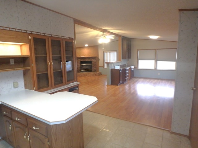 kitchen featuring a peninsula, wallpapered walls, and light countertops