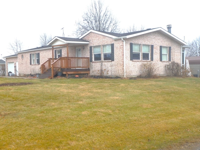 single story home featuring a garage, brick siding, and a front lawn