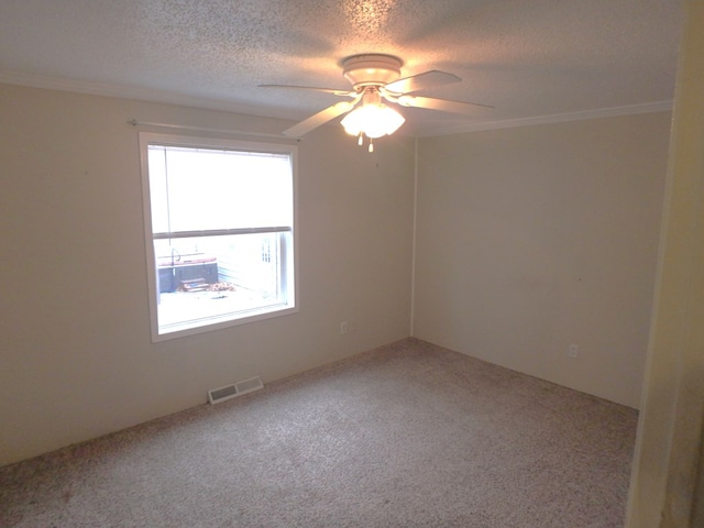 carpeted empty room with ceiling fan, crown molding, visible vents, and a textured ceiling