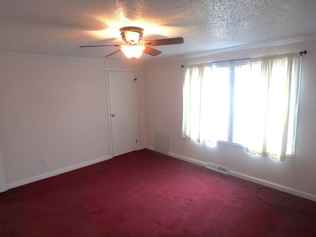 carpeted empty room with ornamental molding, visible vents, a textured ceiling, and baseboards