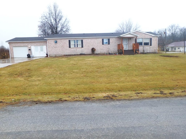 single story home with a garage, concrete driveway, and a front lawn