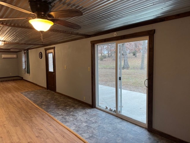 entrance foyer with a wall mounted AC, hardwood / wood-style floors, a wealth of natural light, and ceiling fan