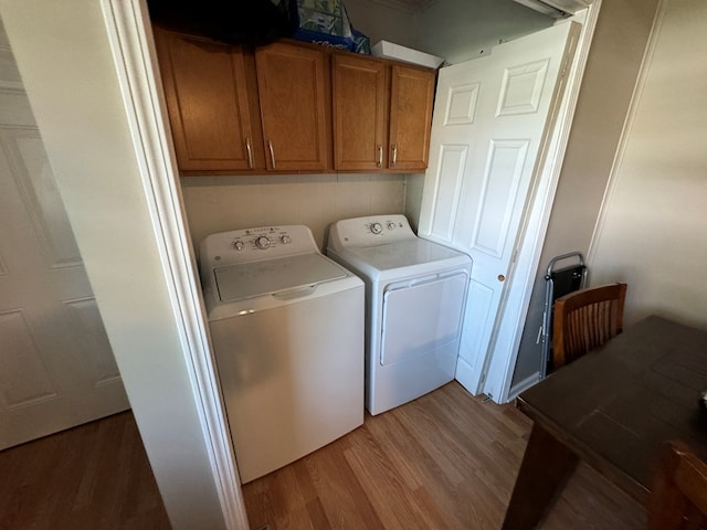 1301 S Ann St, Kirksville, MO 63501 - laundry area featuring independent washer and dryer, light wood-style flooring, and cabinet space