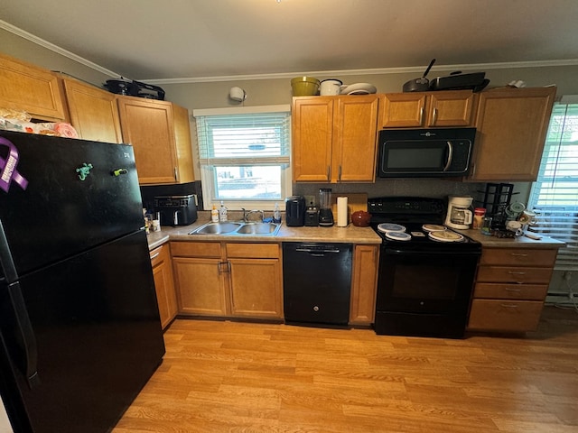 1301 S Ann St, Kirksville, MO 63501 - kitchen with black appliances, light wood-style floors, plenty of natural light, and ornamental molding
