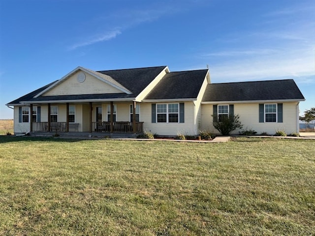 single story home featuring covered porch and a front yard