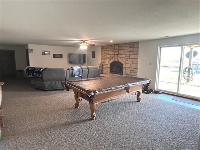 rec room featuring carpet, billiards, ceiling fan, a textured ceiling, and a fireplace