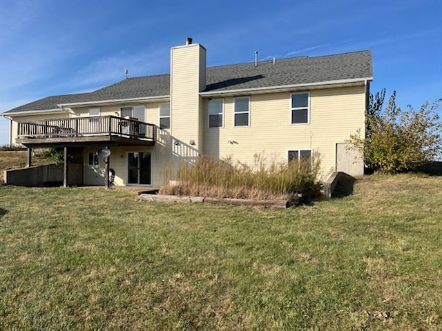 rear view of property with a yard and a deck