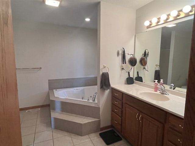 bathroom featuring tile patterned flooring, vanity, and a tub to relax in