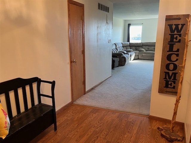 hallway with light hardwood / wood-style floors