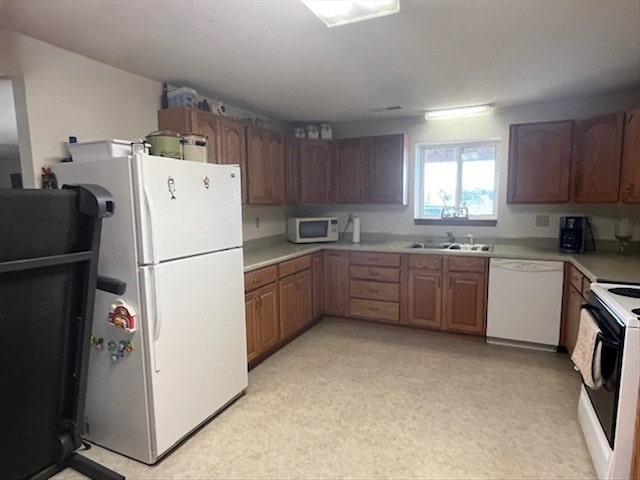 kitchen featuring white appliances and sink