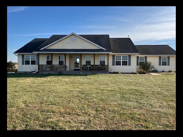 ranch-style home featuring a porch and a front yard