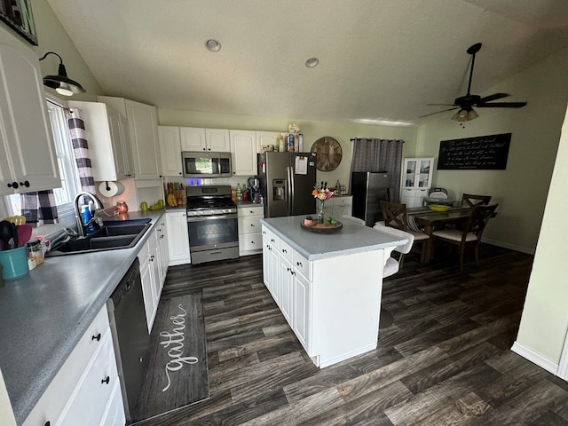 1203 E Randolph St, Kirksville, MO 63501 - kitchen featuring appliances with stainless steel finishes, dark wood finished floors, a ceiling fan, lofted ceiling, and a kitchen island