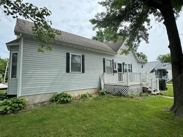 1203 E Randolph St, Kirksville, MO 63501 - back of property featuring a deck, a yard, and roof with shingles