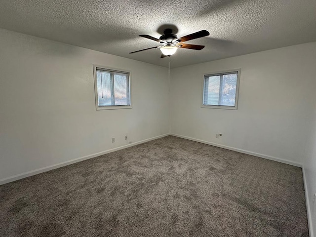 carpeted spare room featuring a textured ceiling and ceiling fan