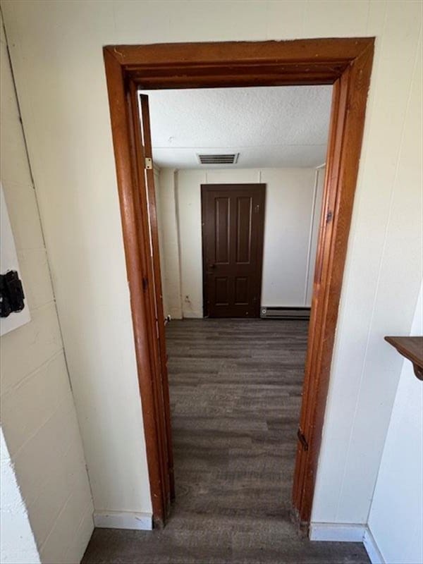 corridor with dark hardwood / wood-style flooring