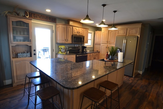 kitchen featuring appliances with stainless steel finishes, dark hardwood / wood-style floors, and a center island