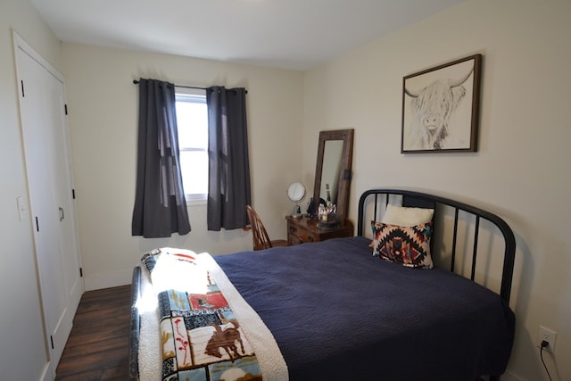 bedroom with dark wood-type flooring