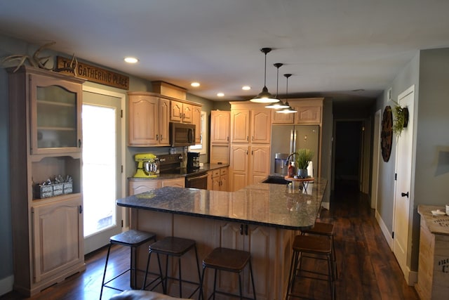 kitchen featuring stainless steel refrigerator with ice dispenser, dark hardwood / wood-style flooring, a kitchen island with sink, and electric range