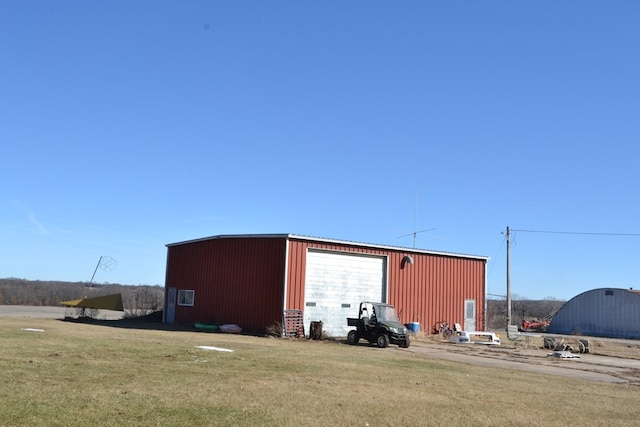 view of outdoor structure featuring a yard and a garage