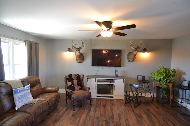 living room with dark wood-type flooring and ceiling fan