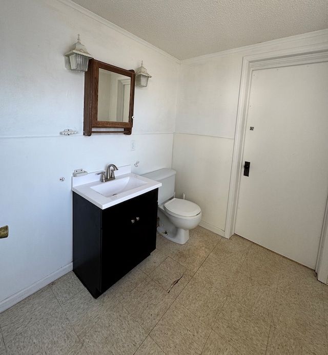 bathroom with tile patterned floors, toilet, a textured ceiling, baseboards, and vanity