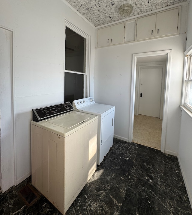 laundry area featuring baseboards, separate washer and dryer, and laundry area