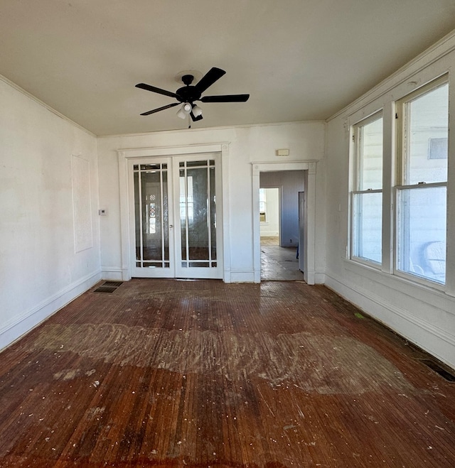 empty room with baseboards, a ceiling fan, and hardwood / wood-style flooring