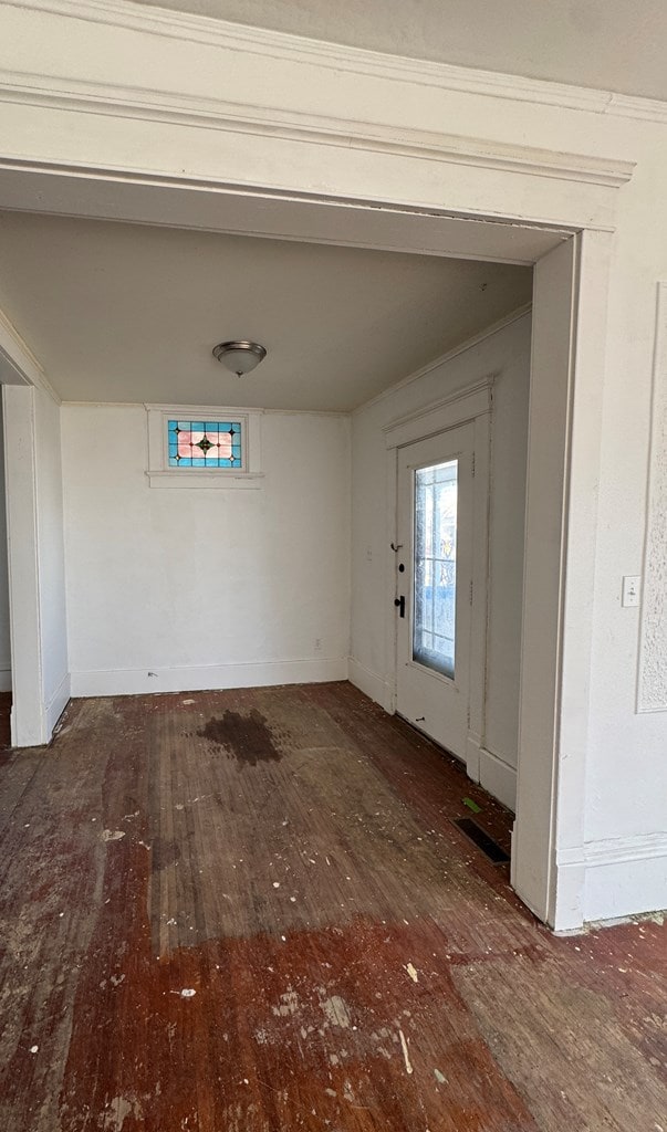 entryway with baseboards and wood finished floors