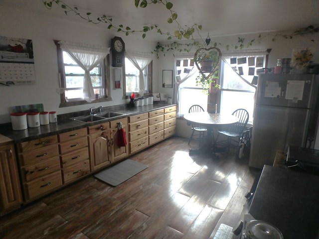 kitchen with white refrigerator, sink, and light hardwood / wood-style flooring