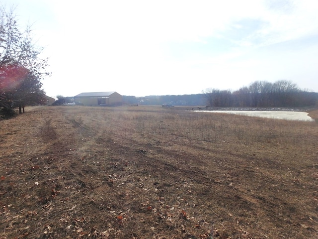 view of yard with a rural view