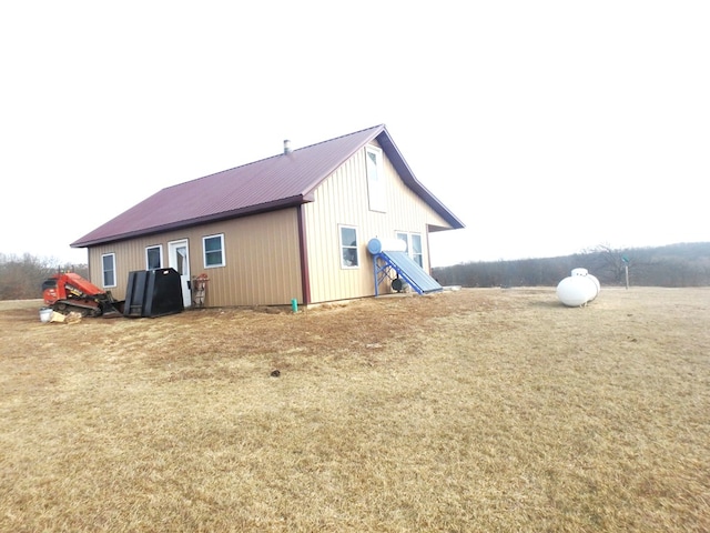 back of house with a lawn