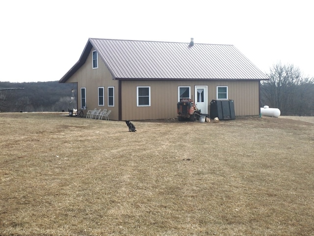 back of house with a lawn