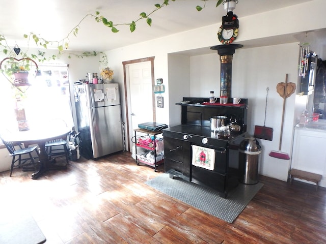 kitchen featuring hardwood / wood-style flooring and stainless steel fridge