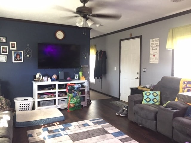 living room featuring ceiling fan, dark hardwood / wood-style floors, and ornamental molding