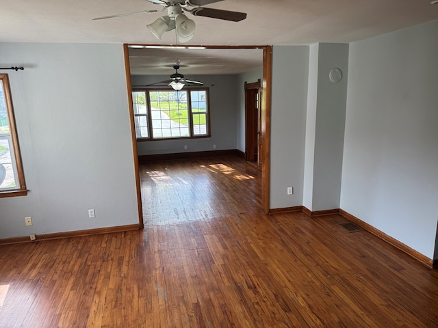 unfurnished room with baseboards, a ceiling fan, and hardwood / wood-style floors