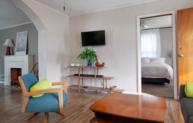 interior space featuring dark hardwood / wood-style floors, ceiling fan, and ornamental molding