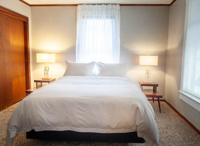 bedroom with multiple windows, a closet, and carpet floors