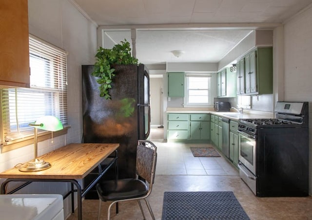 kitchen featuring green cabinets, sink, and appliances with stainless steel finishes