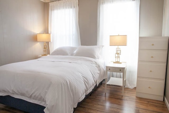 bedroom with dark hardwood / wood-style floors