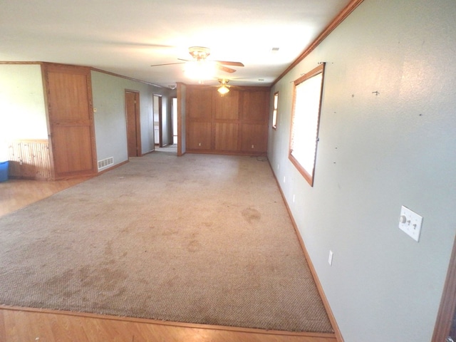 unfurnished room featuring ceiling fan and crown molding