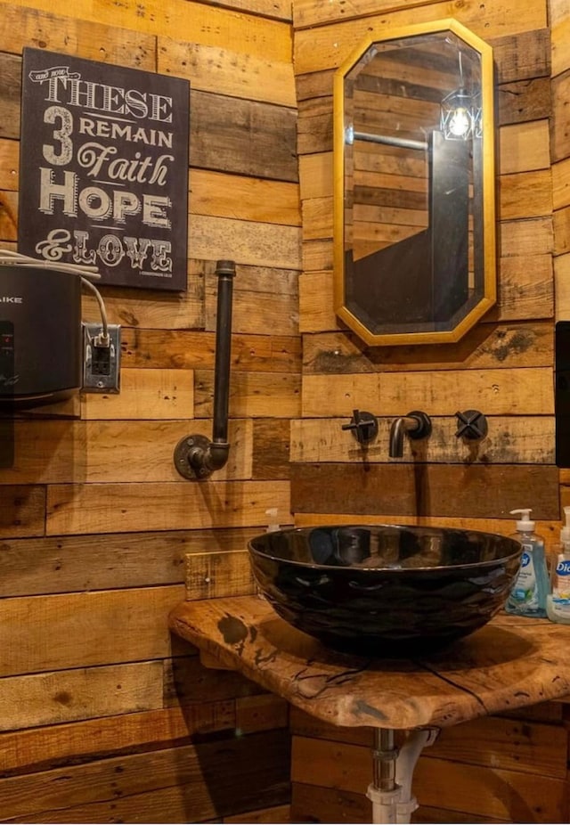 bathroom with wooden walls and sink