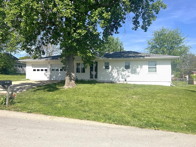 single story home featuring a garage, concrete driveway, and a front yard