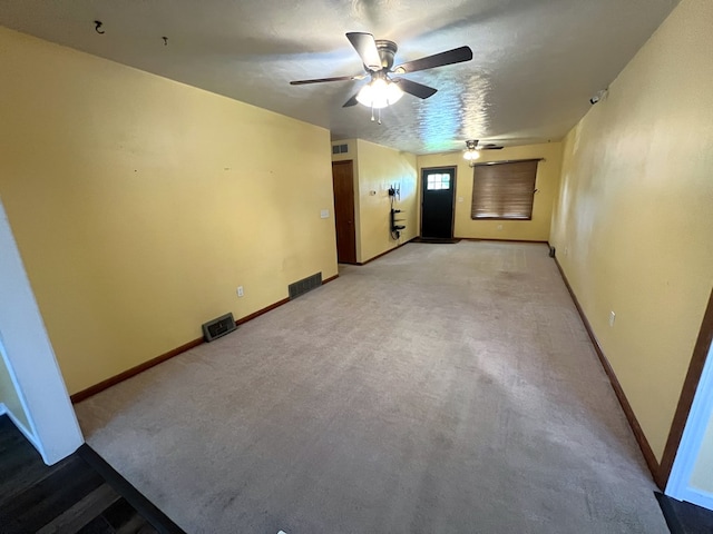unfurnished room featuring ceiling fan, baseboards, and light carpet